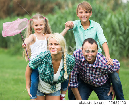 Family of four resting at countryside. Family of four resting at countryside. 35689430
