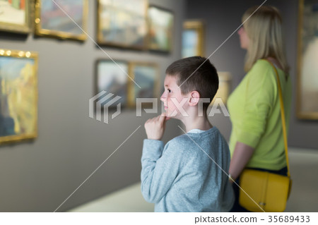Cheerful mother and son exploring paintings 35689433