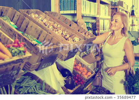 Portrait of woman buying fresh greens and fruits Portrait of woman buying fresh greens and fruits 35689477