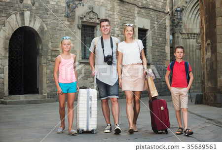 Traveling family walking along city Traveling family walking along city 35689561