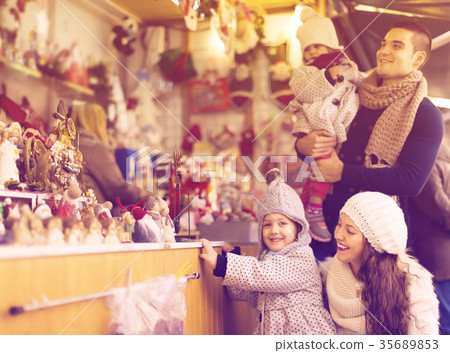 Happy family of four at Christmas market 35689853