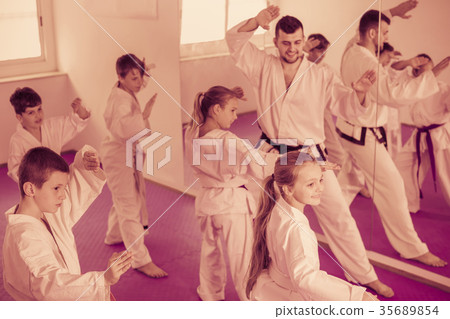 Smiling children attempting to master new moves Smiling children attempting to master new moves 35689854