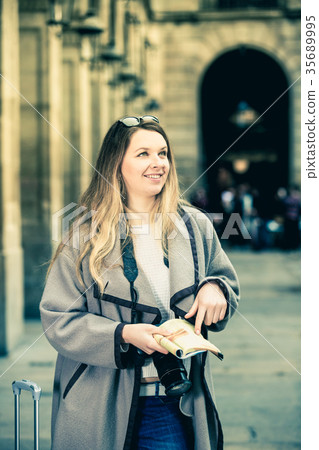 Woman having pamphlet and looking for her route 35689995