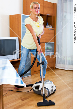 girl hoovering in living room 35690097