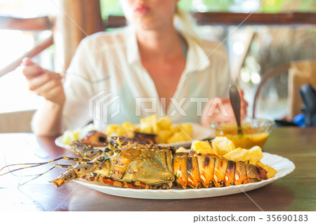 Grilled lobster served with potatoes and coconut 35690183