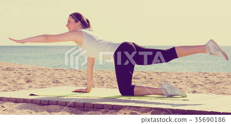 Woman doing yoga sitting 35690186