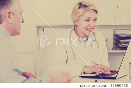 Doctor listens to mature patient Doctor listens to mature patient 35690488