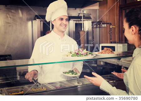Male worker serving customer 35690780