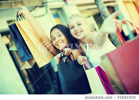 Girls carrying shopping bags Girls carrying shopping bags 35691050