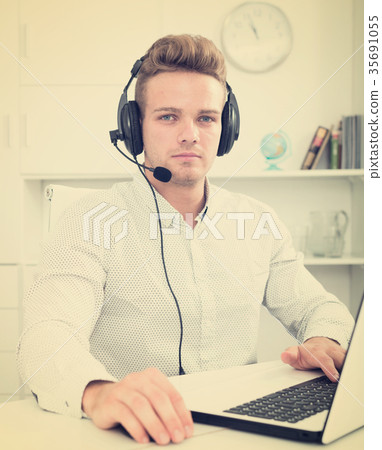 Young man working in call centre Young man working in call centre 35691055