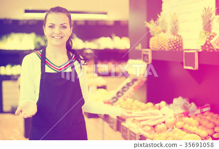 Female seller showing assortment Female seller showing assortment 35691058