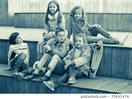 Group of children portrait with ball and skateboard Group of children portrait with ball and skateboard 35691474