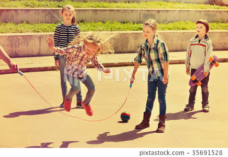 Children playing skipping rope jumping game Children playing skipping rope jumping game 35691528