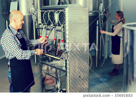 Man working on modern brewery. 35691683