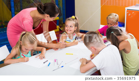 Smiling children drawing pencils on lesson in school 35691975
