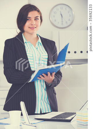 Manager woman is signing agreement papers of financial nature Manager woman is signing agreement papers of financial nature 35692133