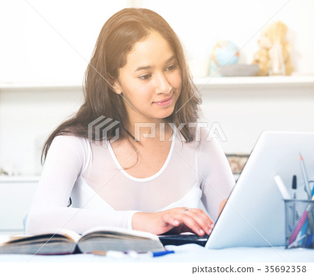 teenager female reading info in laptop 35692358