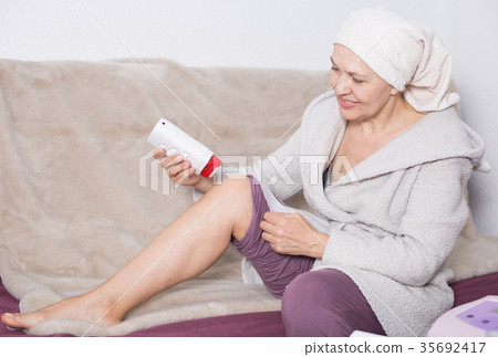 Woman doing body hair removal Woman doing body hair removal 35692417