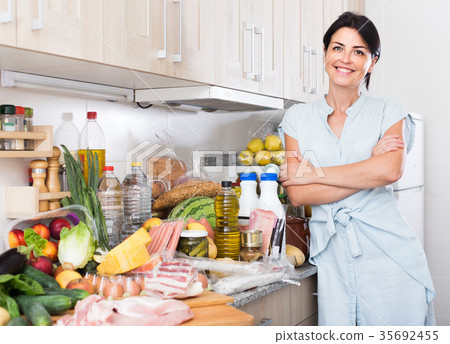 Portrait of woman who is readying for cooking new recipe at home. Portrait of woman who is readying for cooking new recipe at home. 35692455