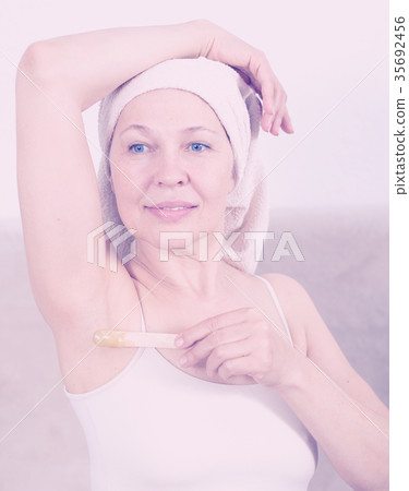 Woman doing body hair removal Woman doing body hair removal 35692456