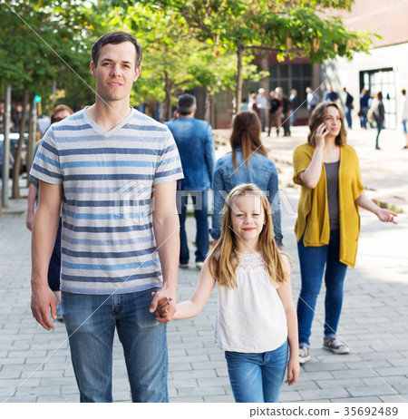 Cheerful father with little glad daughter Cheerful father with little glad daughter 35692489