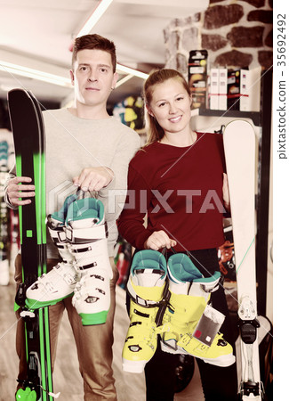 Customers are demonstrating ski and boots Customers are demonstrating ski and boots 35692492