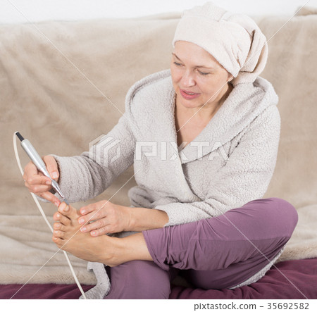 Woman doing pedicure 35692582