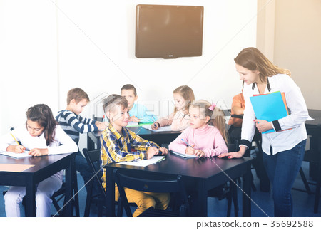 Boys and girls with teacher drawing 35692588
