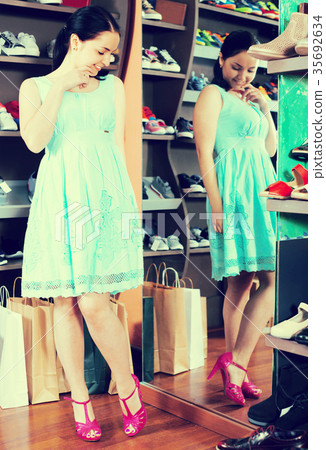 Female is trying on new shoes near the mirror Female is trying on new shoes near the mirror 35692634