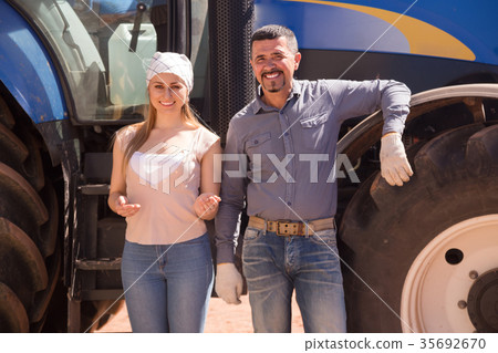 Two farmers near tractor. 35692670