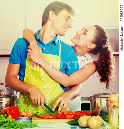 Young family couple cooking vegetables 35692671