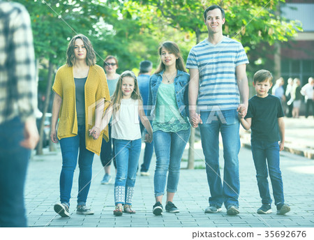 Friendly family going in the park together Friendly family going in the park together 35692676