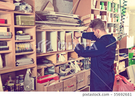Male worker choosing items for work Male worker choosing items for work 35692681