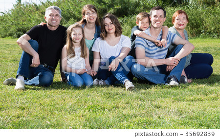People of different ages taking photos on the lawn People of different ages taking photos on the lawn 35692839