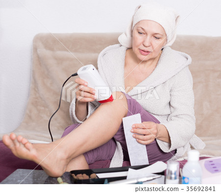 Woman doing body hair removal Woman doing body hair removal 35692841