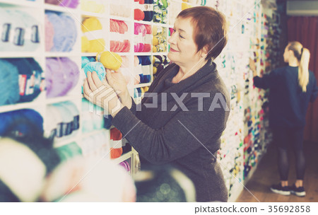 Woman choosing yarn for knitting Woman choosing yarn for knitting 35692858