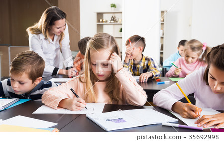 Boys and girls with teacher drawing Boys and girls with teacher drawing 35692998