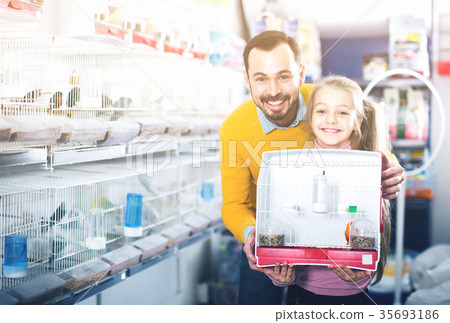 Father and daughter are exult the purchase a canary Father and daughter are exult the purchase a canary 35693186