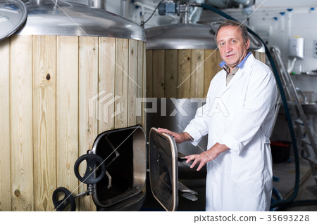 Portrait of brewer who is standing on his workplace 35693228