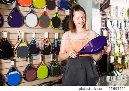 Portrait of female pull line to the racket for tennis Portrait of female pull line to the racket for tennis 35693231