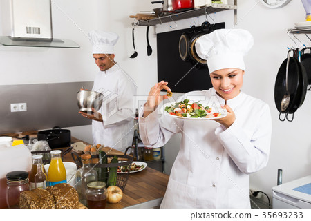 Positive female cook holding plate 35693233