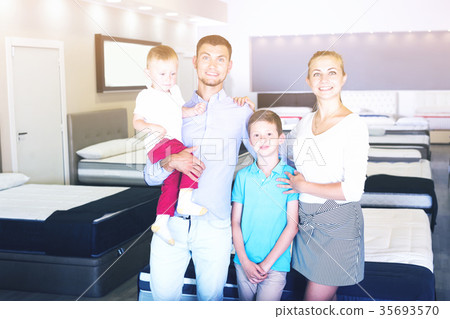 Happy family looking for new mattress in salon Happy family looking for new mattress in salon 35693570