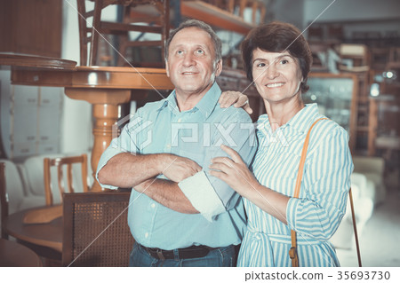 Man with wife are choosing antique furniture 35693730