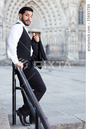 Man standing near iron handrails 35693789