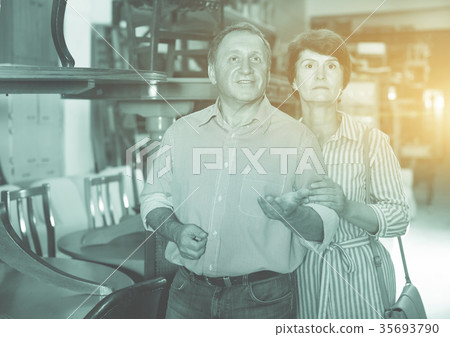Man with wife are choosing antique furniture Man with wife are choosing antique furniture 35693790