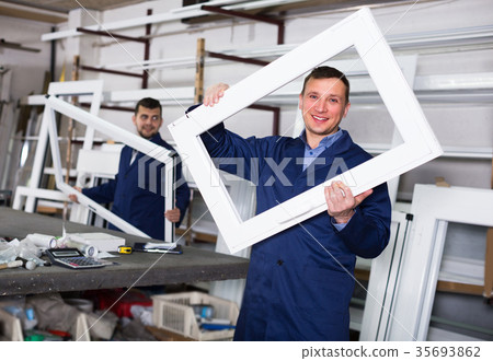 Two workmen are inspecting PVC manufacturing output Two workmen are inspecting PVC manufacturing output 35693862