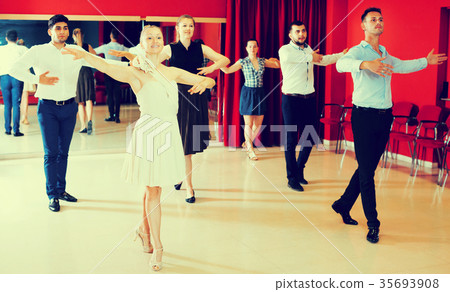 Dancing couples enjoying latin dances Dancing couples enjoying latin dances 35693908