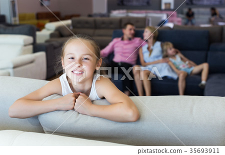 Girl is happy of the purchase of a new sofa Girl is happy of the purchase of a new sofa 35693911