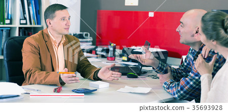 Salesman demonstrating to customer something Salesman demonstrating to customer something 35693928