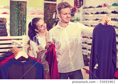 Couple choosing new sportswear in sports store 35693961